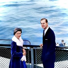 a man and woman standing next to each other on a boat in the water,