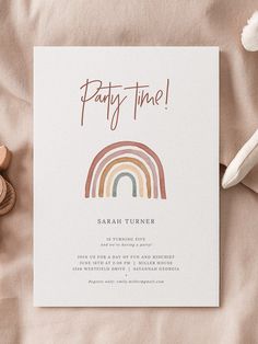 a party time card with a rainbow on it next to some toys and other items