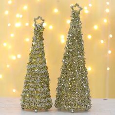 two small christmas trees sitting next to each other