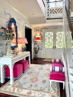 a living room filled with furniture next to a stair case