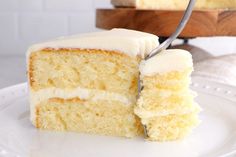 a slice of white cake on a plate with a fork