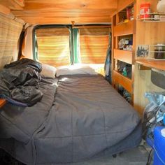 a bed in the back of a small camper