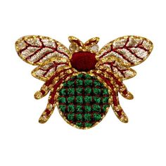 a green and red insect brooch with gold accents