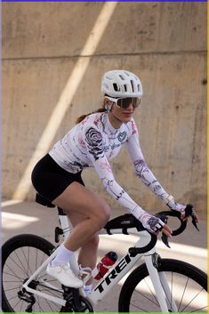 a woman riding a bike down a street