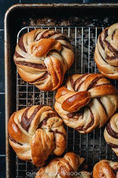 freshly baked cinnamon buns on a cooling rack, ready to be eaten for breakfast