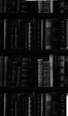 a black and white photo of books on a book shelf