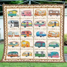 a quilt is hanging on a clothesline in front of a house with rvs