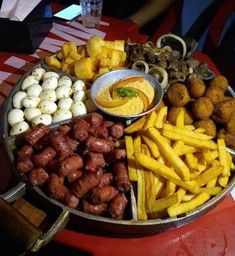 a platter filled with lots of different types of food on top of a table