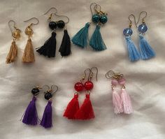 These earrings are made with tassels in various colors and glass beads to match each tassel. On a gold plated stainless steel hook Adjustable Tassel Earrings As Gift, Adjustable Beaded Earrings With Tassels As Gift, Adjustable Beaded Tassel Earrings As Gift, Elegant Adjustable Tassel Earrings With Round Beads, Elegant Tassel Earrings With Round Beads, Adjustable Tassel Earrings For Gifts, Multicolor Dangle Tassel Earrings With Beads, Traditional Festive Tassel Drop Earrings, Gold Tassel Earrings With Colorful Beads