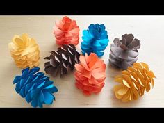 several different types of paper flowers on a table