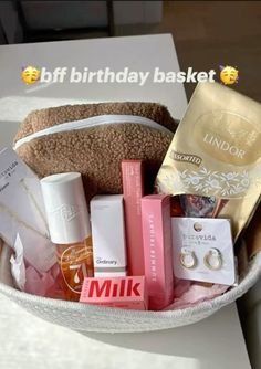 a white basket filled with lots of different types of items on top of a table