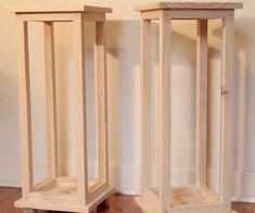 two tall wooden stands sitting on top of a hard wood floor