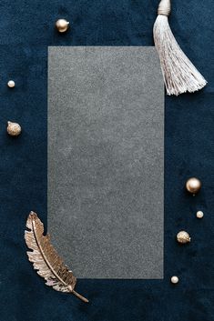 an empty paper surrounded by gold ornaments and feathers