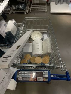 a shopping cart filled with items on top of a store floor