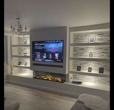 a large flat screen tv mounted to the side of a wall in a living room