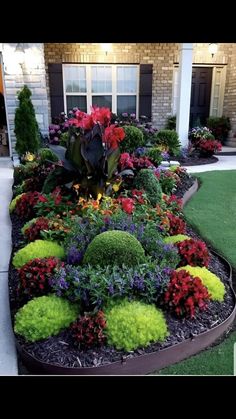 a flower garden in front of a house