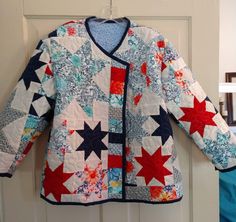 a jacket hanging on a door with red, white and blue stars all over it