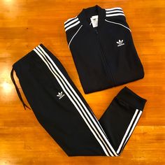 Top Of The Line And Classic Adidas Black W/White Stripes Tracksuit. Heavyweight Poly/Cotton Blend, Regular Fit, And Very Comfortable. Full Zip Jacket Has Ribbed Hem, Cuffs, And Collar (Collar Tapers Down At Front), Front Zip Pockets, Adidas Trefoil Logo On Left Chest, And The Classic 3-Stripes Down Each Arm With Additional Striping From Front To Back. Matching Pants Have Elastic/Drawstring Waist, Elastic Cuffs, Zip Up Pockets, And Trefoil Logo On Left Thigh. Nwt Mint Condition. Nhb5x7ttd Red Adidas Pants, Soccer Sweatpants, Adidas Track Pants Mens, Adidas Soccer Pants, Sports Track Pants, Soccer Pants, Adidas Sweats, Track Pants Mens, Pants Adidas