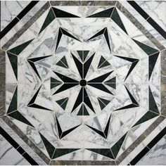 a marble floor with a black and white design on the top, in an octagonal pattern