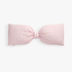 a pink pillow with a bow on it