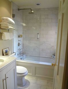 a bathroom with a toilet, sink and bathtub