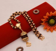 "Handmade  Self Design Powerful Om with Paro Fancy Design Gold Plated Rudraksha Mala with Pendant DESCRIPTION :-  Be assured that the product you order is MADE JUST FOR YOU and is not a mass produced item. Mala Dimension Height:63 cm (24.8 inch) Width:7 mm (0.7 cm) Depth:7 mm (0.7 cm) Pendant Dimension Height:53 mm (5.3 cm) Width:19 mm (1.9 cm) Depth:19 mm (1.9 cm) Other Specification Weight:41 Gram Size:Fixed Lock Type:S Hook Color:Golden Material:Brass, Rudraksha Surface Finish:Shining, Matt, Rudraksha Gold Bracelet For Men, Rudraksha Jewelry, Rudraksha Mala, Romantic Surprise, Fancy Design, Art Deco Pendant, Healing Necklace, S Hook, Presents For Her