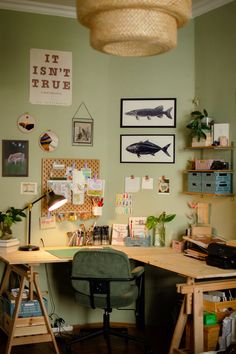 a home office with desk, chair and pictures on the wall above it's desk