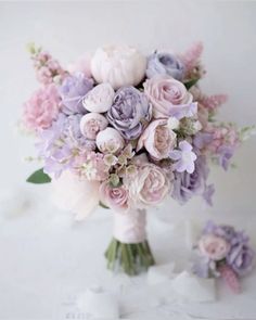 a bridal bouquet with pink and purple flowers