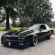 a black sports car parked in a parking lot