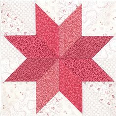 a red and white quilted star is shown