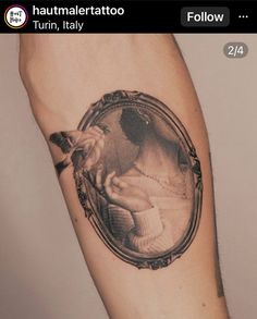 a man's arm with a tattoo on it and an image of a woman in a mirror