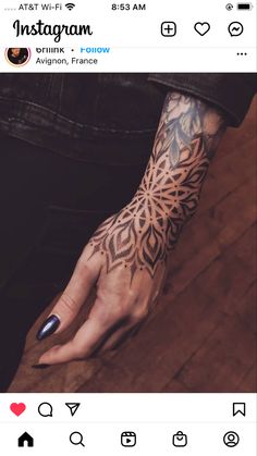 a woman's hand with an intricate tattoo design on her left arm and wrist