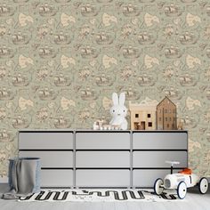 a toy car is sitting on top of a dresser in front of a wallpapered background