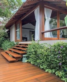 a wooden deck with steps leading up to a house