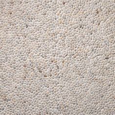 a close up view of a wall made out of rocks and pebbles, with no one on it