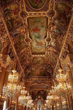 an ornate room with chandeliers and paintings on the ceiling