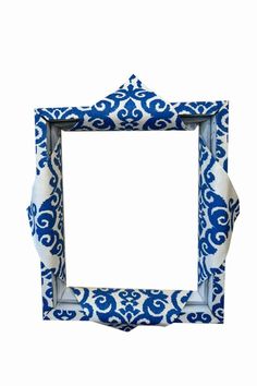 a blue and white photo frame with an ornate pattern on the front, against a white background