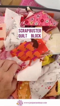 someone is cutting fabric with scissors in a box full of quilts and other material