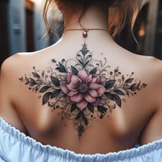 the back of a woman's neck with a flower tattoo on her left shoulder