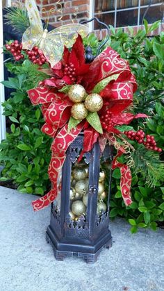 a red and gold christmas decoration on top of a lantern