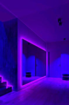 an empty room with purple lighting on the walls