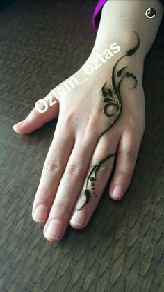 someones hand with a tattoo on it