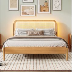 a bed with pillows and pictures on the wall above it in a room that has carpeted flooring