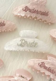 several pink hair combs sitting on top of a white fur covered floor