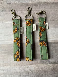 three key fobs with butterflies on them