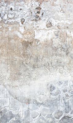 an old wall with peeling paint on it and a red fire hydrant in the foreground