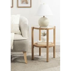 a white lamp sitting on top of a table next to a chair in a living room