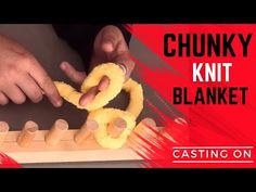 the chunk knit blanket is being used to make an object with yarn and wood pegs