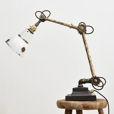 an old fashioned desk lamp on a wooden stool