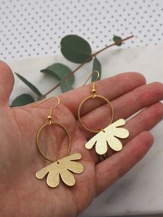 Brass hoop earrings with gold plated hooks. 3.4cm x 1.8cm brushed brass flower shapes sitting on 2.5cm brass hoops with gold plated hooks. Postage: All jewellery items are posted by 1st class recorded delivery with Royal mail, so that you are able to track your order. UK : FREE INTERNATIONAL : £8.00 Brass Drop Earrings With Flower Charm, Metal Drop Earrings With Flower Charm, Metal Flower Charm Drop Earrings, Gold Metal Flower Charm Earrings, Single Metal Flower Earring, Gold Metal Earrings With Flower Charm, Small Hoop Earrings In Gold-tone Brass, Gold-tone Small Hoop Brass Earrings, Gold Hoop Flower Earrings, Single